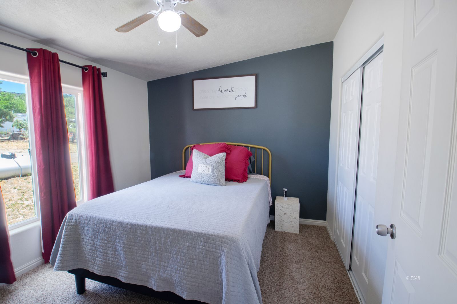 591 Spring Valley Parkway Spring Creek, NV 89815 - Photo 15 of 25 a bedroom with a bed and a large window