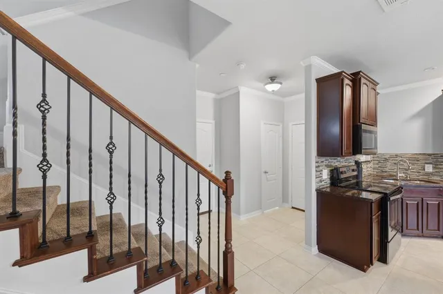 a view of a kitchen with stainless steel appliances granite countertop a stove top oven