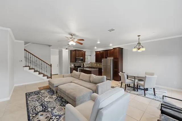 a living room with furniture and a chandelier