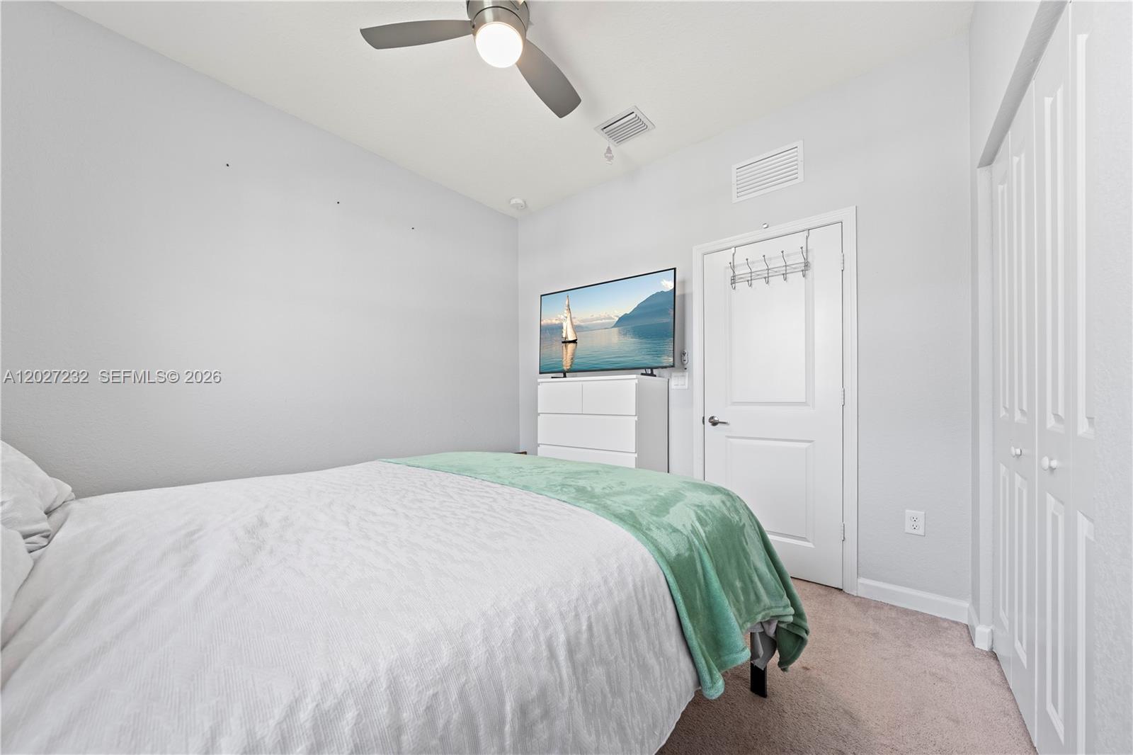 23489 Southwest 127th Place Homestead, FL 33032 - Photo 16 of 24 a bedroom with a bed and cabinets