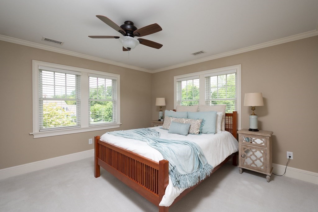 6 High Meadow Road Andover, MA 01810 - Photo 24 of 32 a bedroom with a bed chandelier and a window
