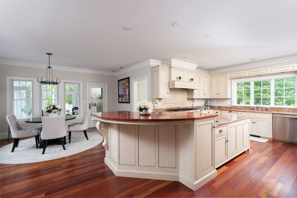 6 High Meadow Road Andover, MA 01810 - Photo 8 of 32 a large kitchen with kitchen island a white cabinets and wooden floor