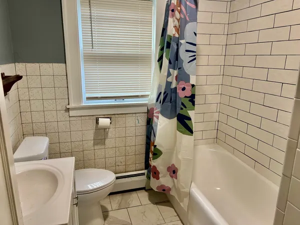 a bathroom with a toilet and shower