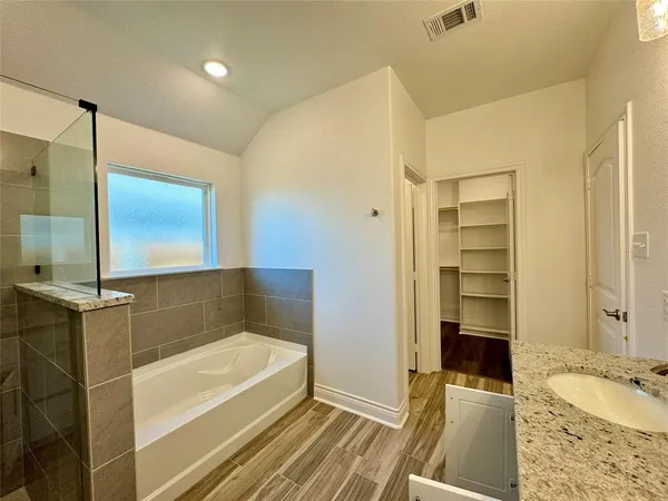 a bathroom with a tub and a sink