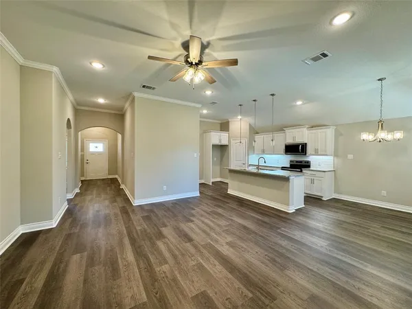a view of kitchen with cabinets and wooden floor