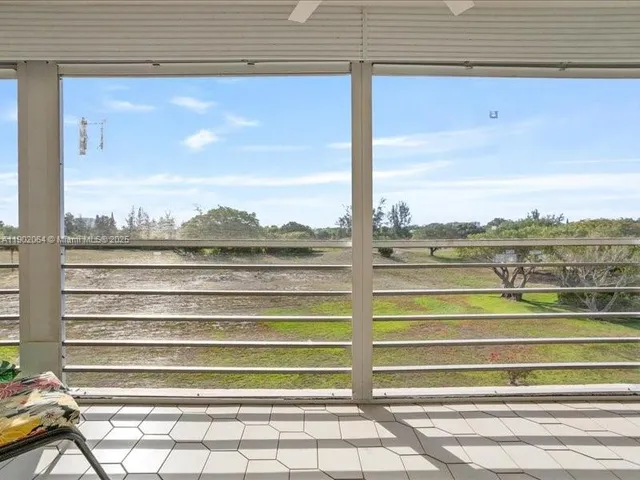 a view of a balcony with chairs and a table