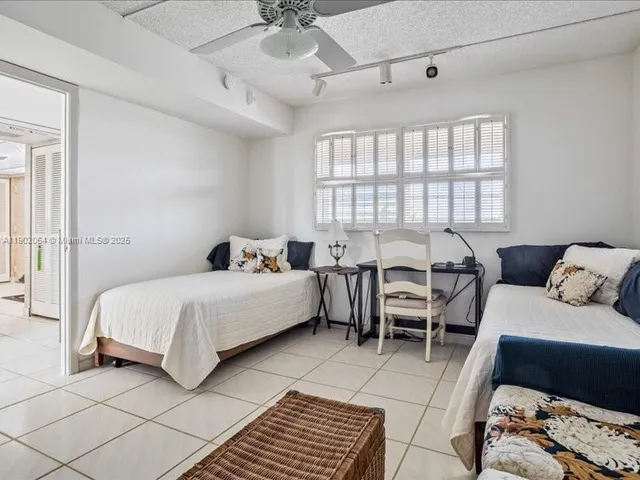 a spacious bedroom with a bed a couch and a window