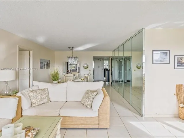 a living room with furniture and a glass door