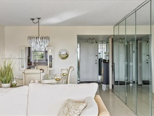 a dining room with chandelier table and chairs