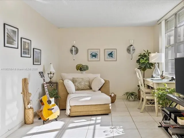 a living room with furniture a rug and a lamp