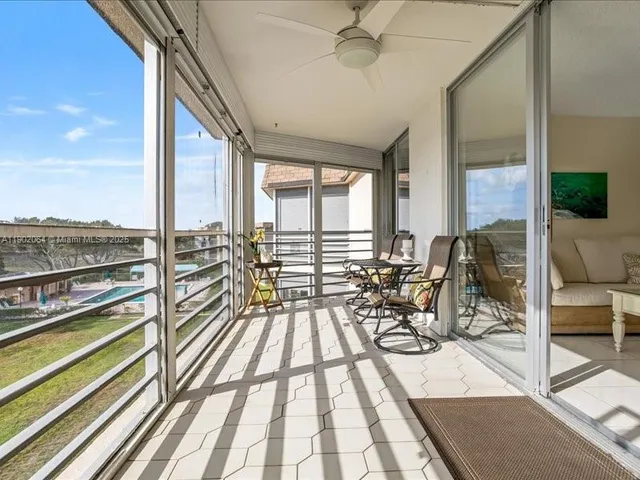 a view of a living room and floor to ceiling window or couch