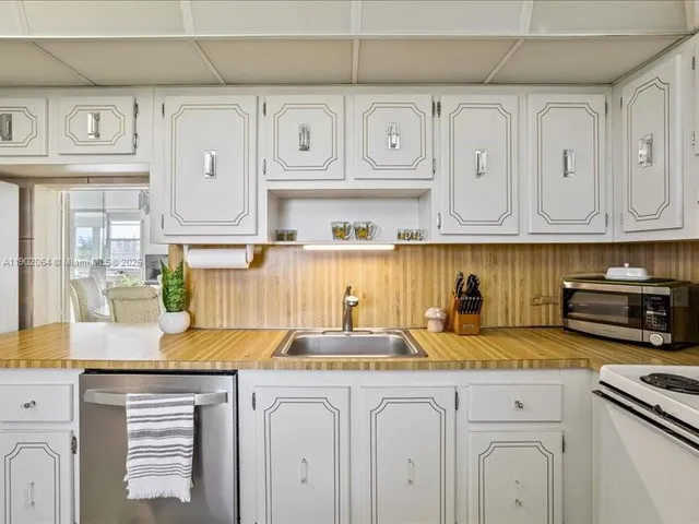 a kitchen with stainless steel appliances granite countertop a sink and cabinets