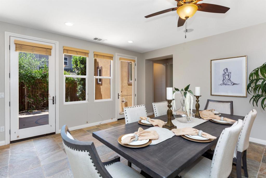 1415 Eclipse Drive San Marcos, CA 92078 - Photo 19 of 57 a dining room with furniture a large window and chandelier