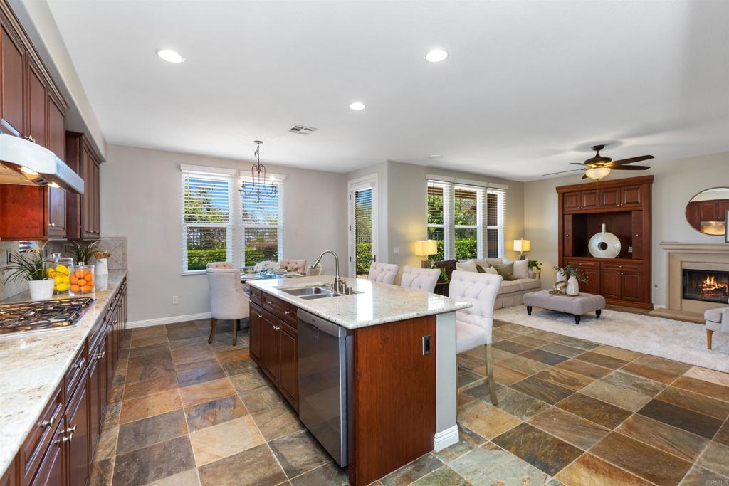 1415 Eclipse Drive San Marcos, CA 92078 - Photo 29 of 57 a open kitchen with stainless steel appliances kitchen island granite countertop a sink and cabinets