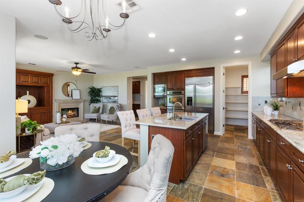 1415 Eclipse Drive San Marcos, CA 92078 - Photo 30 of 57 a large kitchen with a table and chairs in it