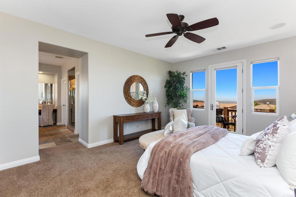 1415 Eclipse Drive San Marcos, CA 92078 - Photo 39 of 57 a bedroom with a large bed and a fireplace