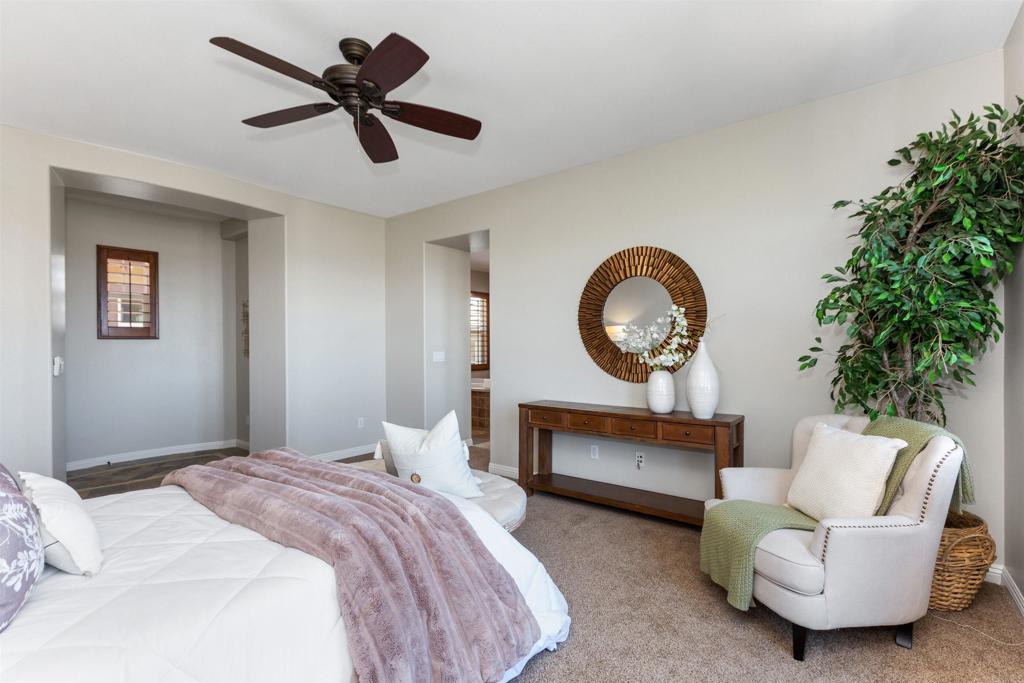 1415 Eclipse Drive San Marcos, CA 92078 - Photo 40 of 57 a bedroom with a bed a couch and a potted plant