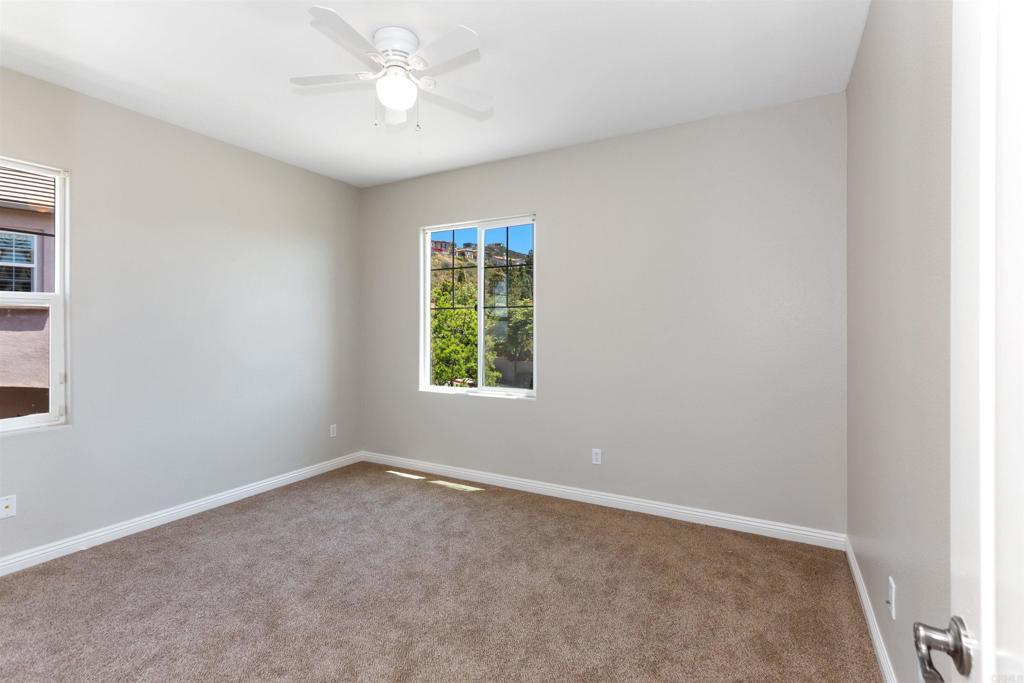 1415 Eclipse Drive San Marcos, CA 92078 - Photo 51 of 57 an empty room with a window and a fan