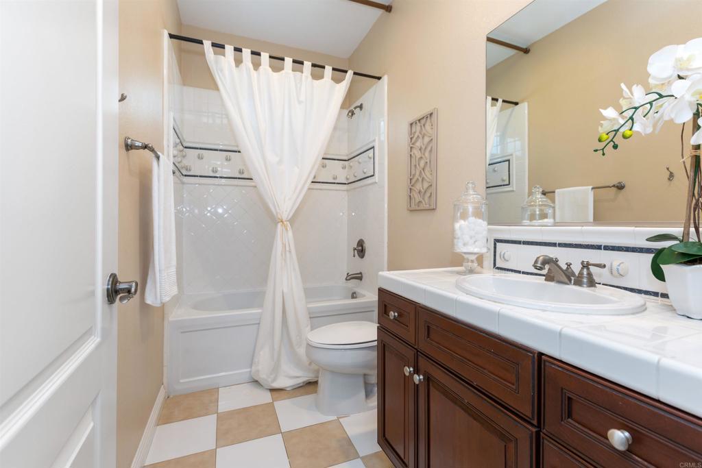 1415 Eclipse Drive San Marcos, CA 92078 - Photo 53 of 57 a bathroom with a granite countertop sink toilet and shower
