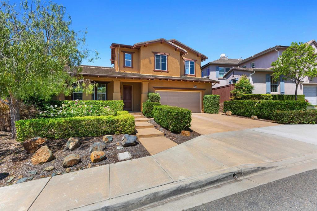 1415 Eclipse Drive San Marcos, CA 92078 - Photo 10 of 57 a front view of a house with a yard and garage