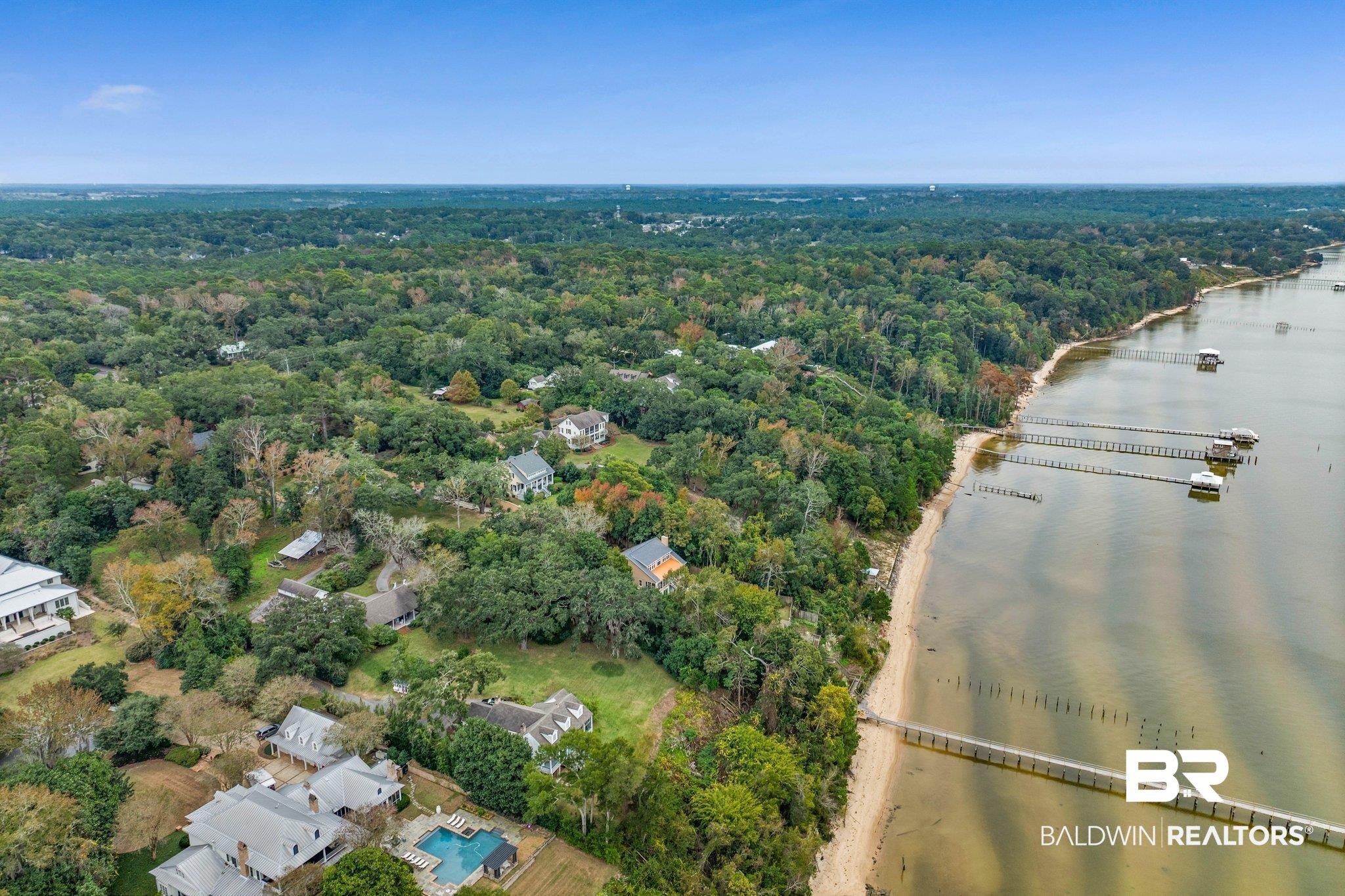 23561 Main Street Fairhope, AL 36532 - Photo 34 of 45 Aerial view of a nearby body of water and a heavily wooded area