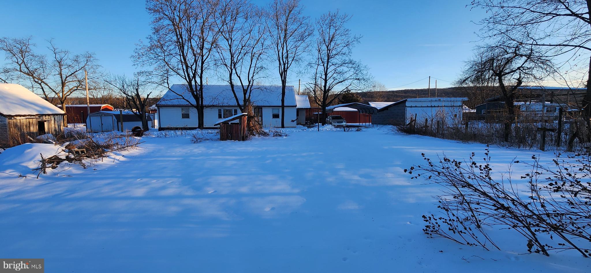 3250 Big Spring Road Blain, PA 17006 - Photo 7 of 20 a view of a backyard with table and chairs with wooden fence and plants