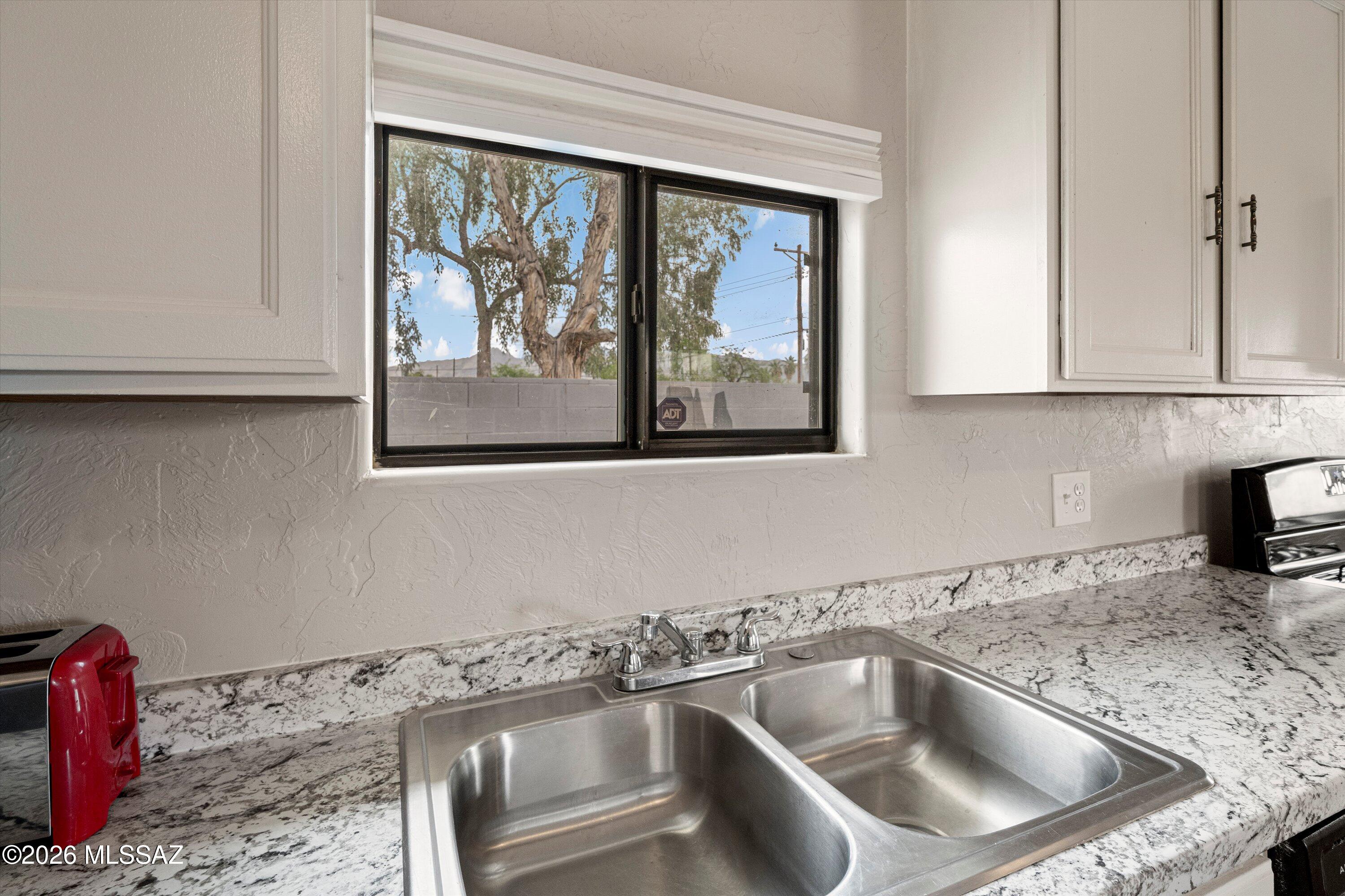 2841 North Richey Boulevard Tucson, AZ 85716 - Photo 13 of 30 a close view of a sink a faucet and appliance in the kitchen