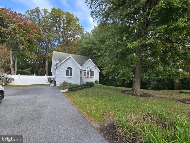 a view of a livingroom with a window and wooden floor