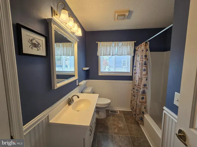a view of a livingroom with a ceiling fan and window