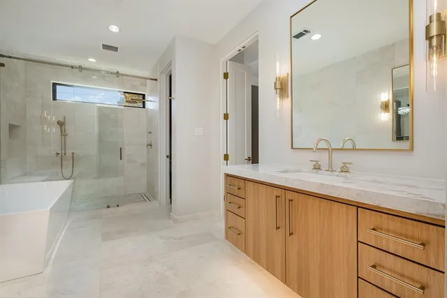 a bathroom with a shower sink and mirror