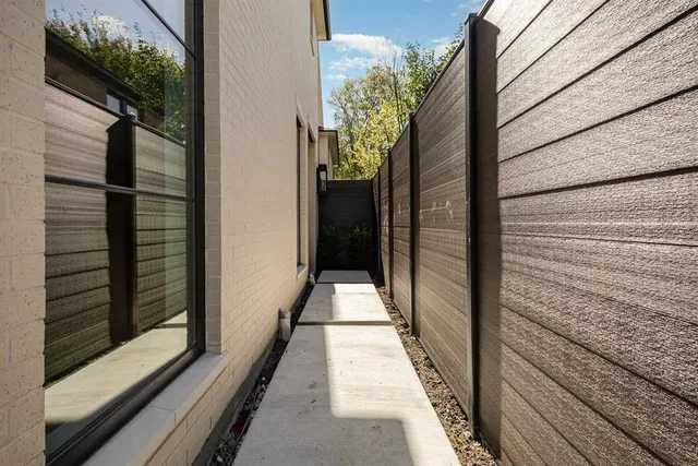 a view of an empty room with glass door and balcony