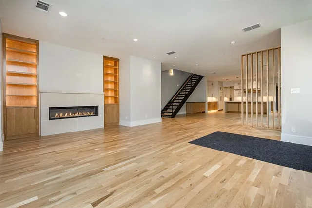 a view of an empty room with glass door and balcony