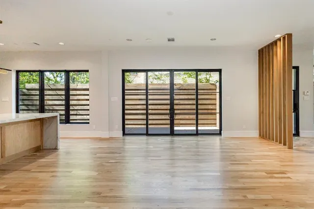 a kitchen with stainless steel appliances granite countertop a sink a stove and a wooden floors