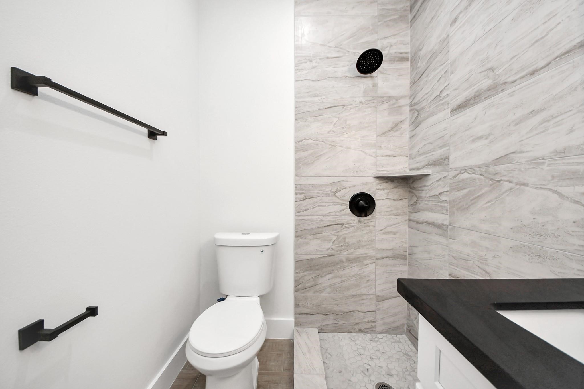 8015 Elbert Street, Unit A/B Houston, TX 77028 - Photo 11 of 12 a bathroom with a toilet and a shower