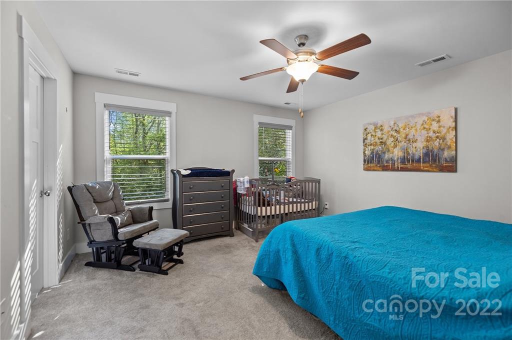 30 Rose Street York, SC 29745 - Photo 14 of 31 a bedroom with a bed a couch and a chandelier