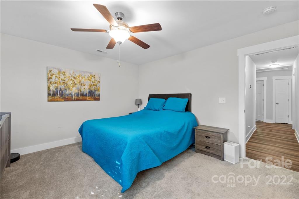 30 Rose Street York, SC 29745 - Photo 15 of 31 a bedroom with a bed and a chandelier