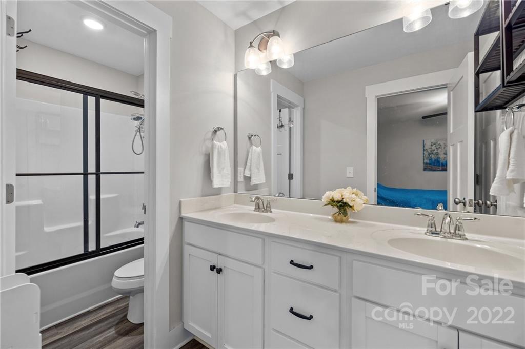 30 Rose Street York, SC 29745 - Photo 16 of 31 a bathroom with a granite countertop sink toilet a large mirror a shower and vanity