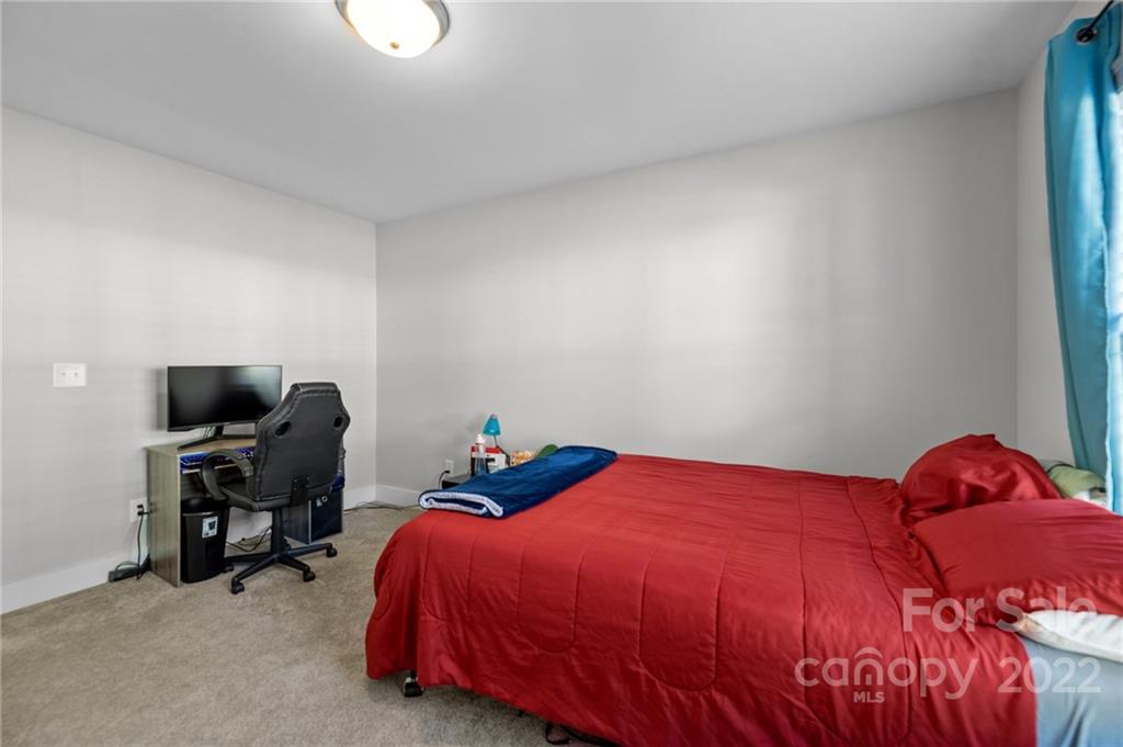 30 Rose Street York, SC 29745 - Photo 20 of 31 a bedroom with a bed and a flat screen tv