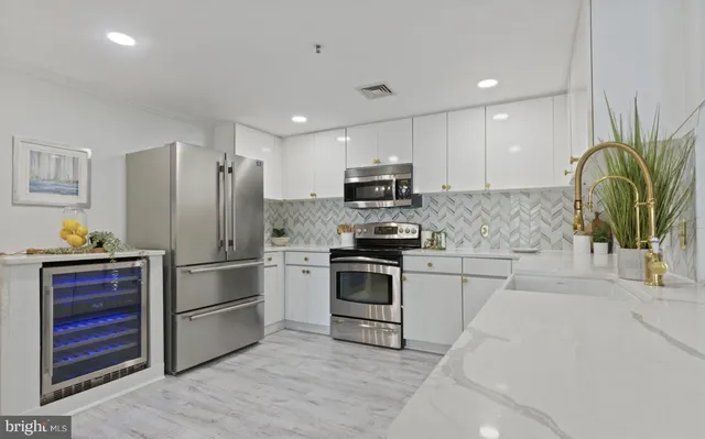 a kitchen with a refrigerator a stove top oven a sink and dishwasher