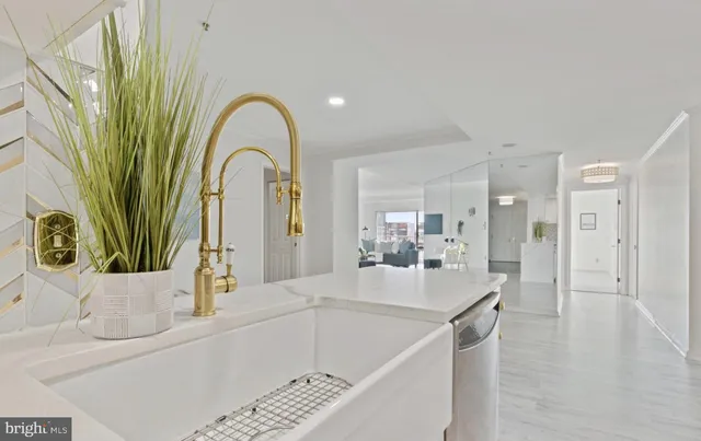 a large white kitchen with a large window