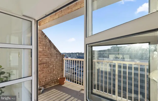 a view of a kitchen with a sink and refrigerator