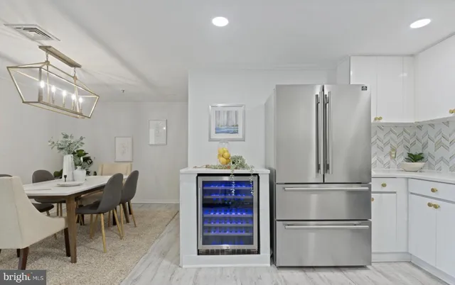 a kitchen with stainless steel appliances granite countertop a refrigerator and a stove top oven