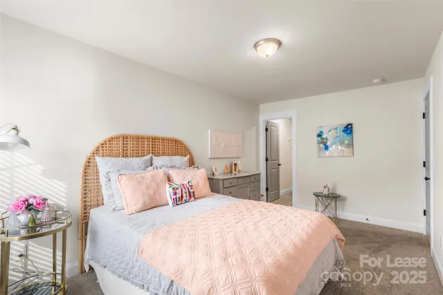 a bedroom with a bed and a potted plant