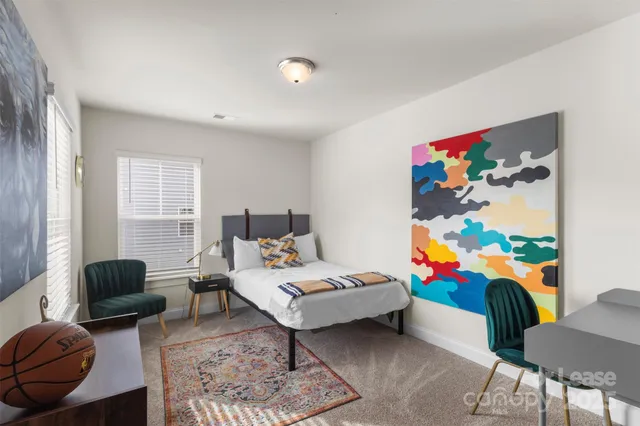 a bedroom with a bed and a couch