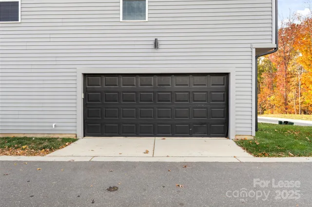 a view of house with a garage