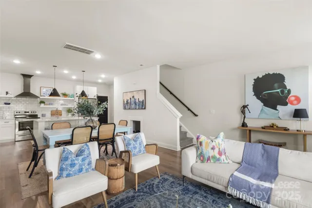 a living room with furniture and kitchen view
