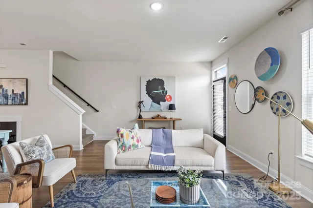 a living room with furniture and a mirror