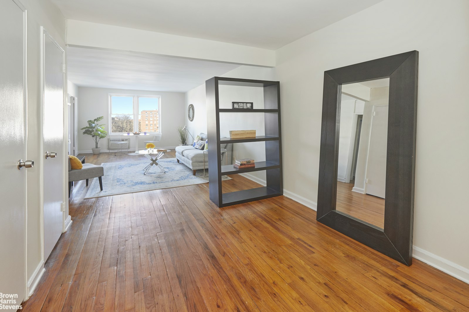 131 74th Street, Unit 3B Brooklyn, NY 11209 - Photo 3 of 10 a view of a livingroom with wooden floor and furniture