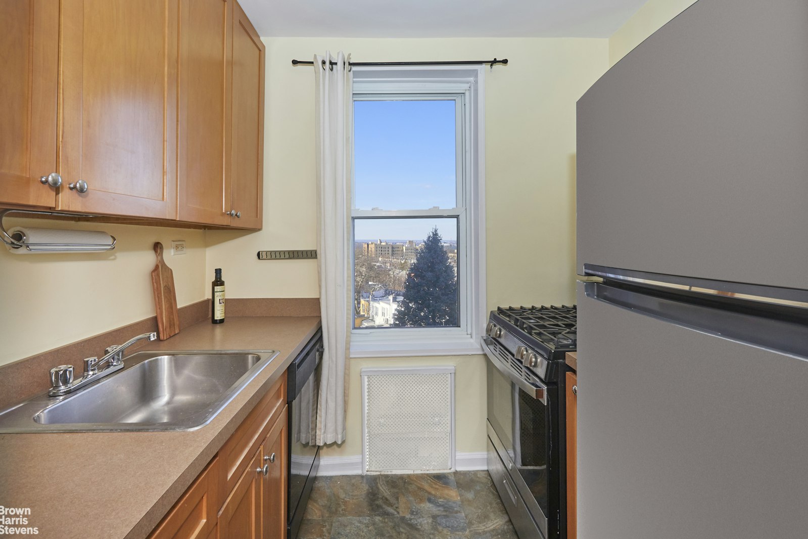 131 74th Street, Unit 3B Brooklyn, NY 11209 - Photo 4 of 10 a kitchen with a sink stove and refrigerator