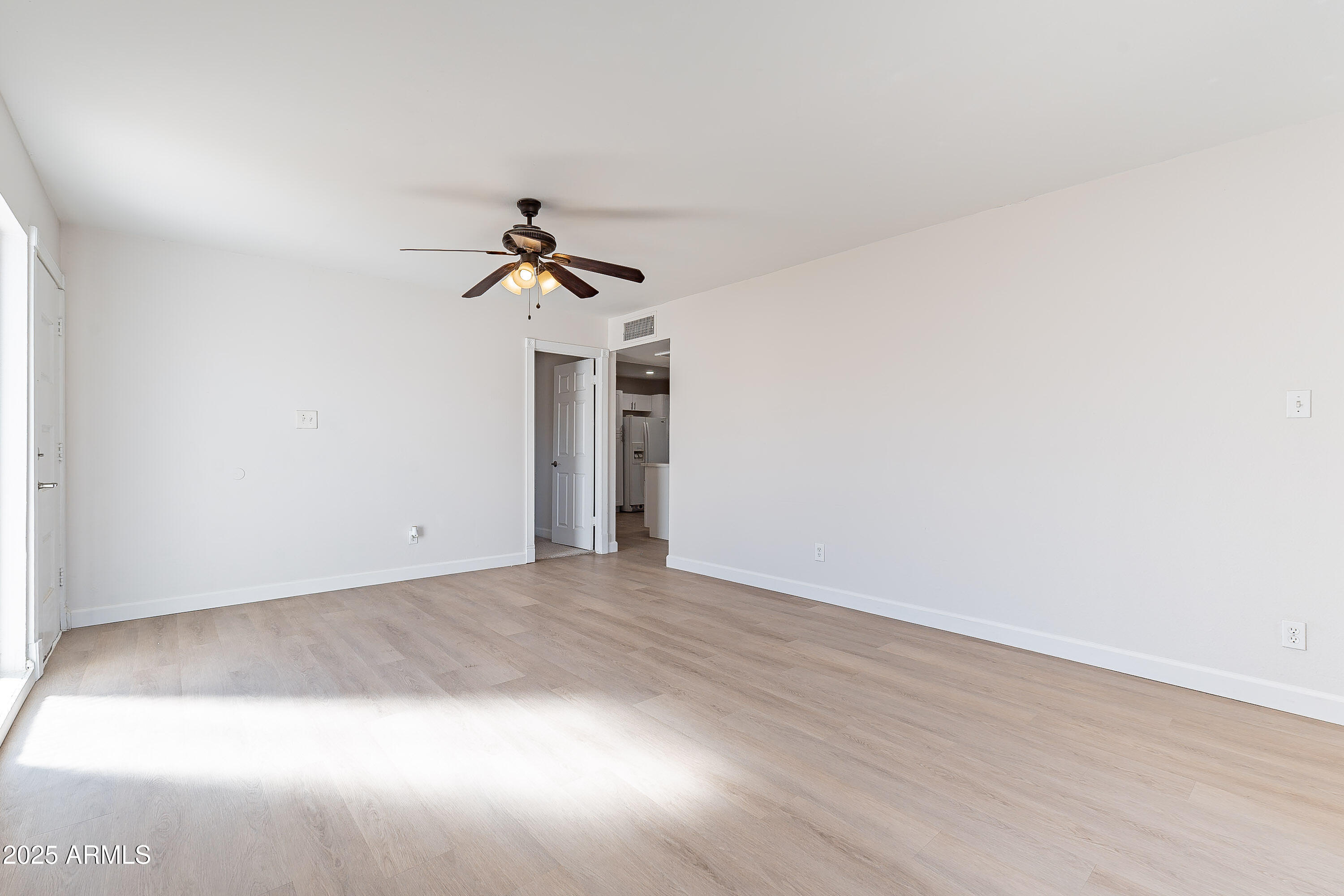 7508 West Osborn Road Phoenix, AZ 85033 - Photo 4 of 17 a view of empty room with wooden floor